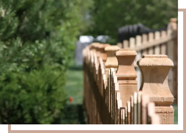 a long wooden fence with post caps