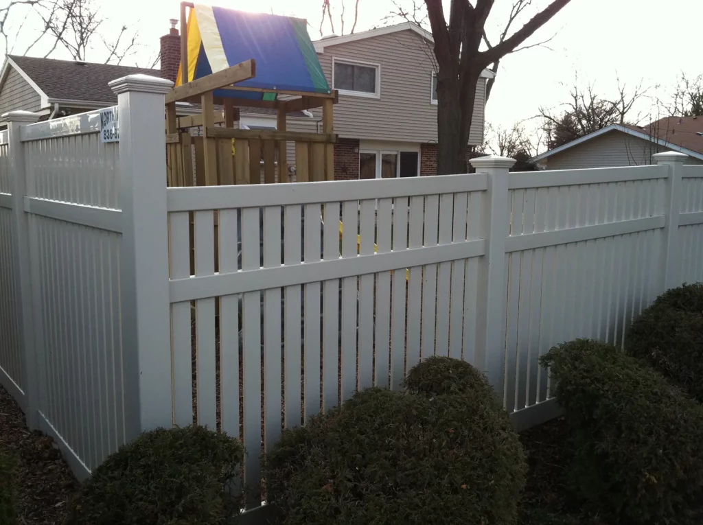 spaced vinyl fence wrapping around a background with a playset