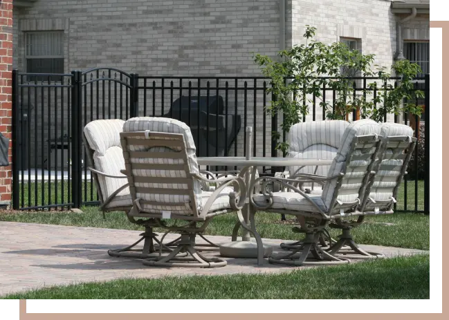 patio set with aluminum fence around backyard